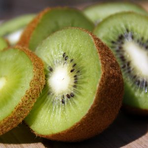 The sliced fruits of the reliably cropping, self fertile kiwi plant Actinidia deliciosa 'Solo' on a plate.